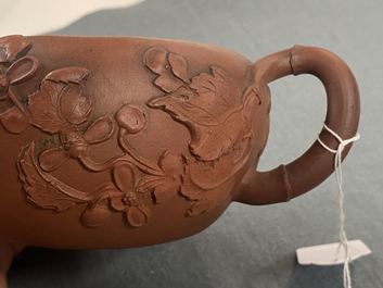 A Chinese Yixing stoneware teapot and cover with applied floral design, Kangxi